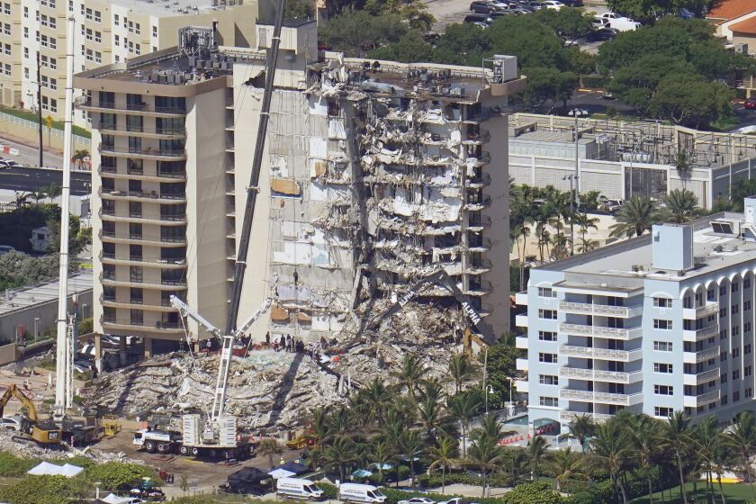 Crews work in the rubble at the Champlain Towers South Condo, Sunday, June 27, 2021, in Surfside, Fla. One hundred fifty-nine people were still unaccounted for two days after Thursday's collapse. (AP Photo/Gerald Herbert)