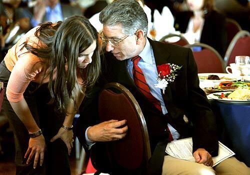 Angelides confers with his daughter, Megan Garcia, before an appearance in Monterey Park.