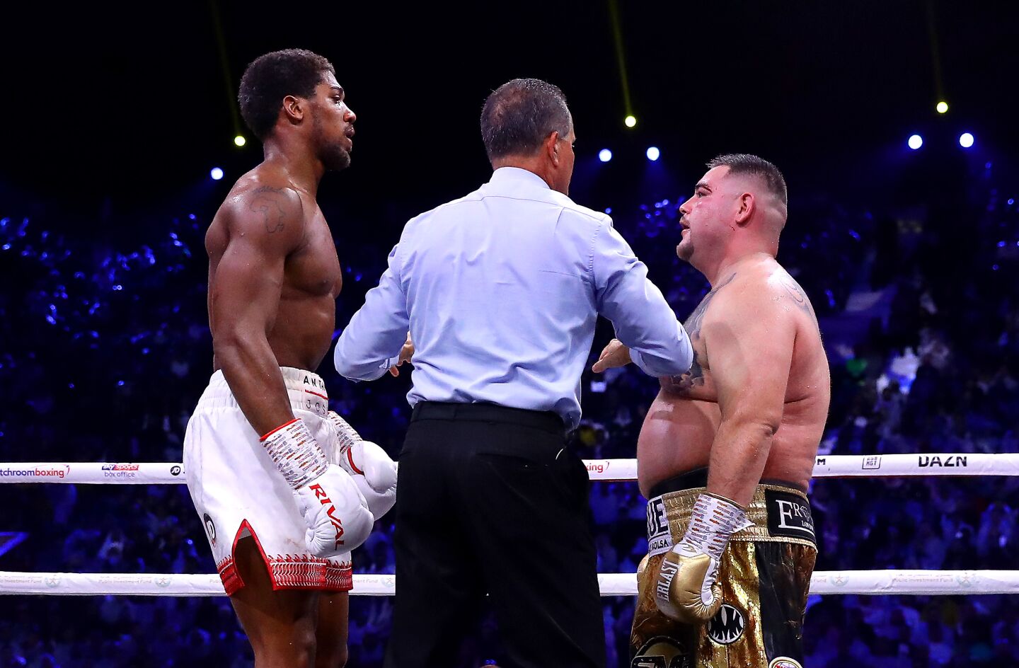 Referee Luis Pabon speaks to Anthony Joshua and Andy Ruiz Jr during their heavyweight title fight on Dec. 7 in Diriyah, Saudi Arabia.