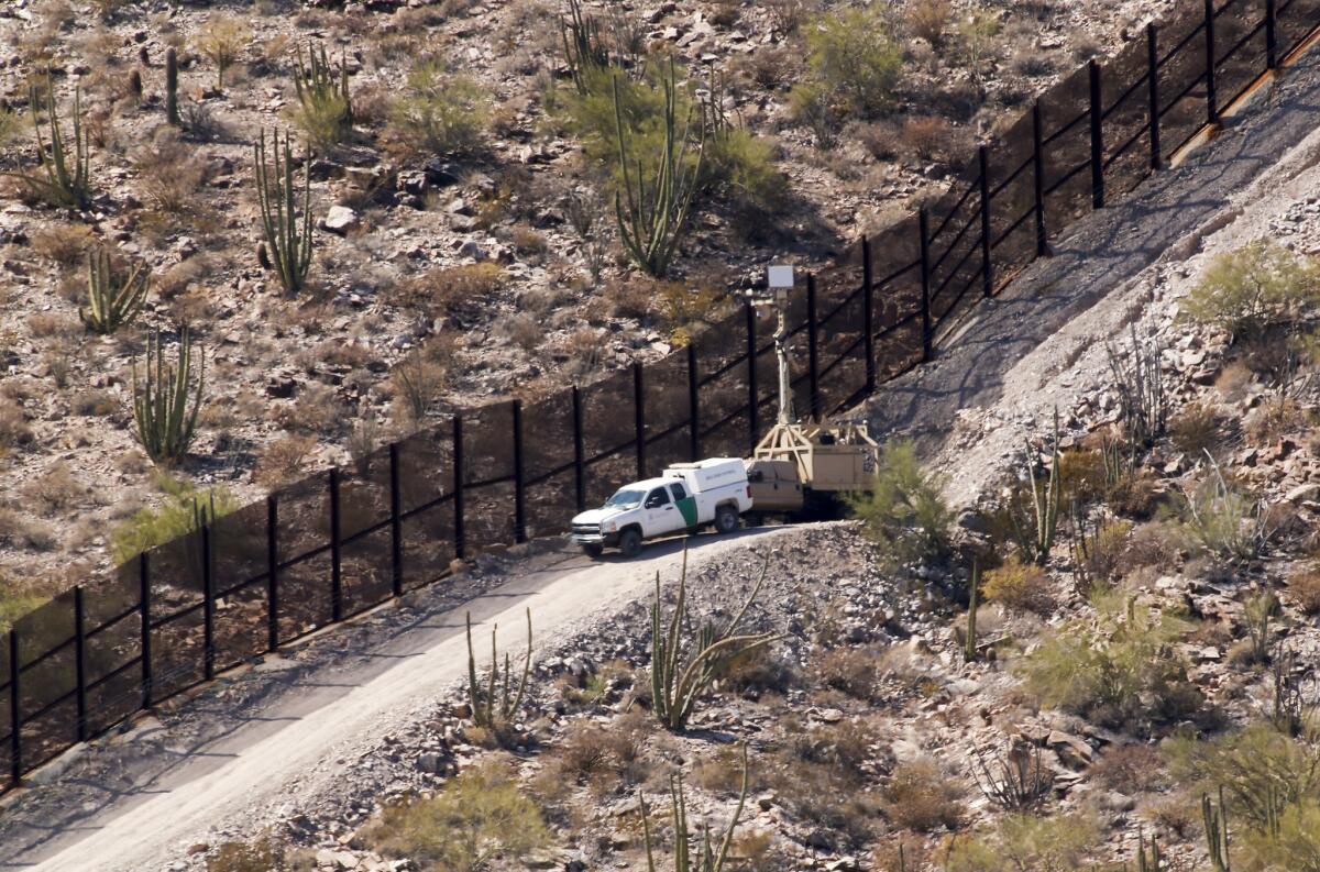 U.S. Customs and Border Protection vehicles man the metal border fence with trucks, cameras and regular patrols in the park.