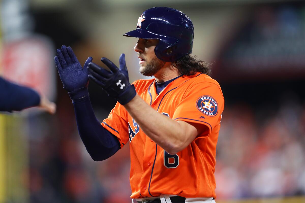 Jake Marisnick claps after hitting a single for the Houston Astros against the Washington Nationals.