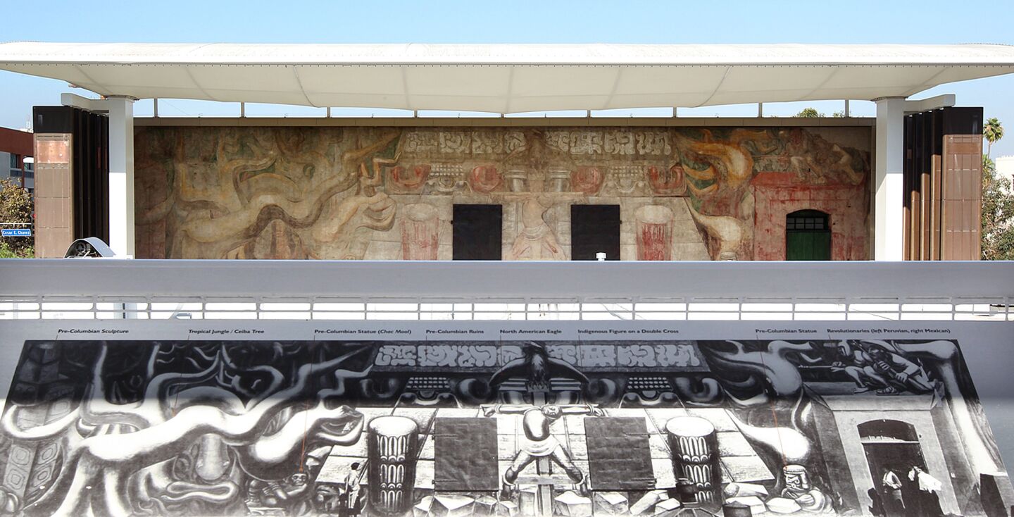 A restored Olvera Street mural by Mexican artist David Alfaro Siqueiros, top, is seen from a viewing deck at the America Tropical Interpretive Center that offers a description of the mural, bottom.