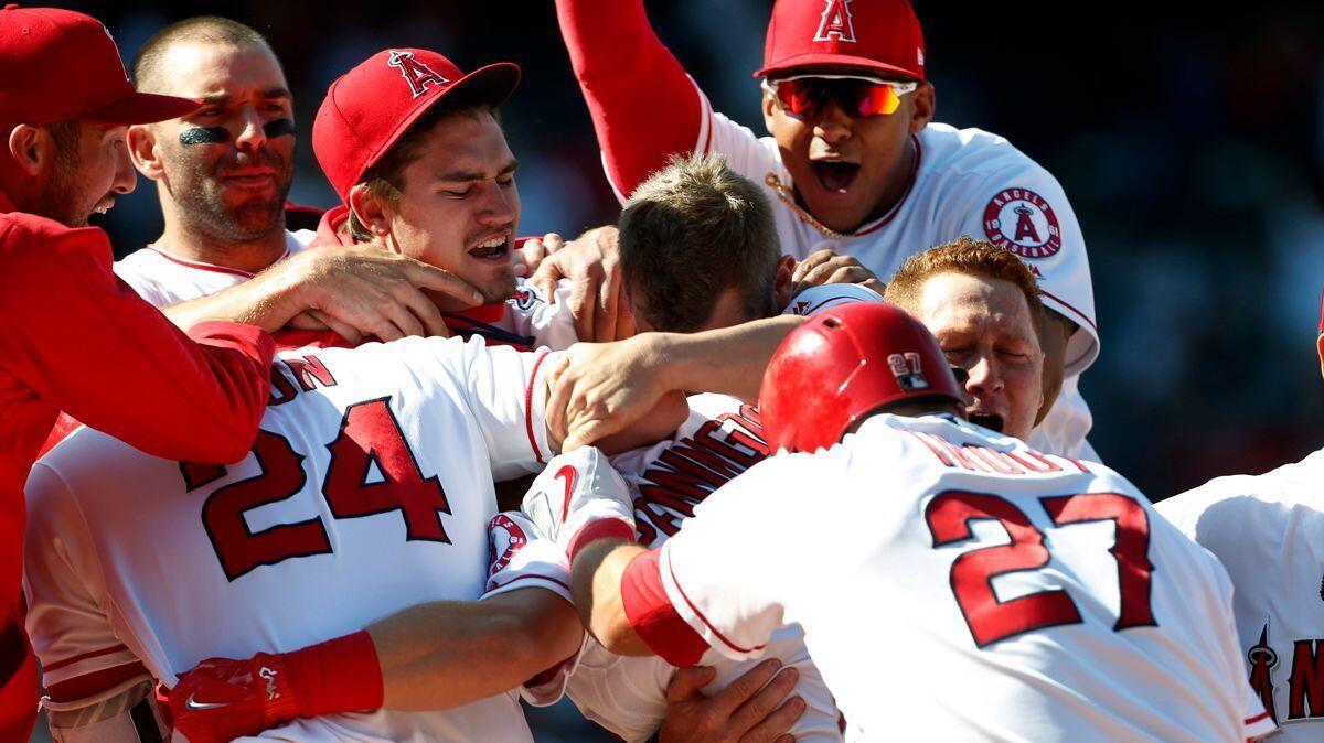 Angels players celebrate a 10-9 victory over the Seattle Mariners on April 9.