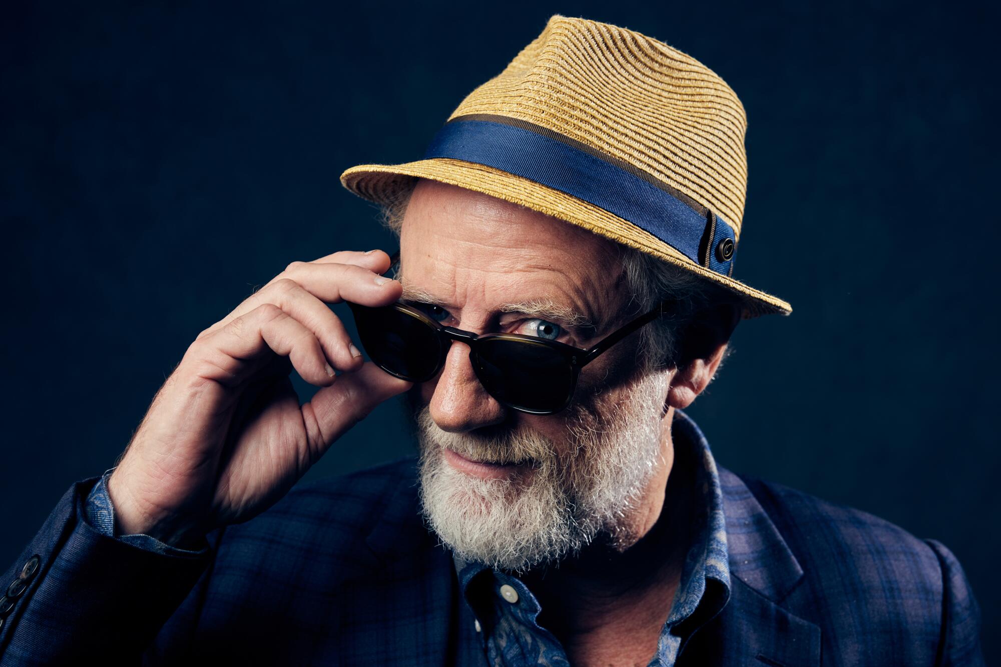 A man in sunglasses and a hat.