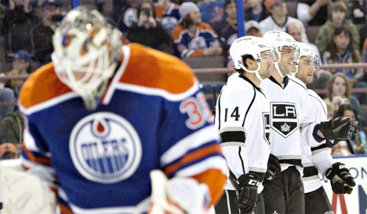 Edmonton goalie Viktor Fasth, left, lowers his head after allowing a goal Thursday while Justin Williams (14), Marian Gaborik, center, and Alec Martinez, right, celebrate. Gaborik had two goals in the Kings' 3-0 win over the Oilers.