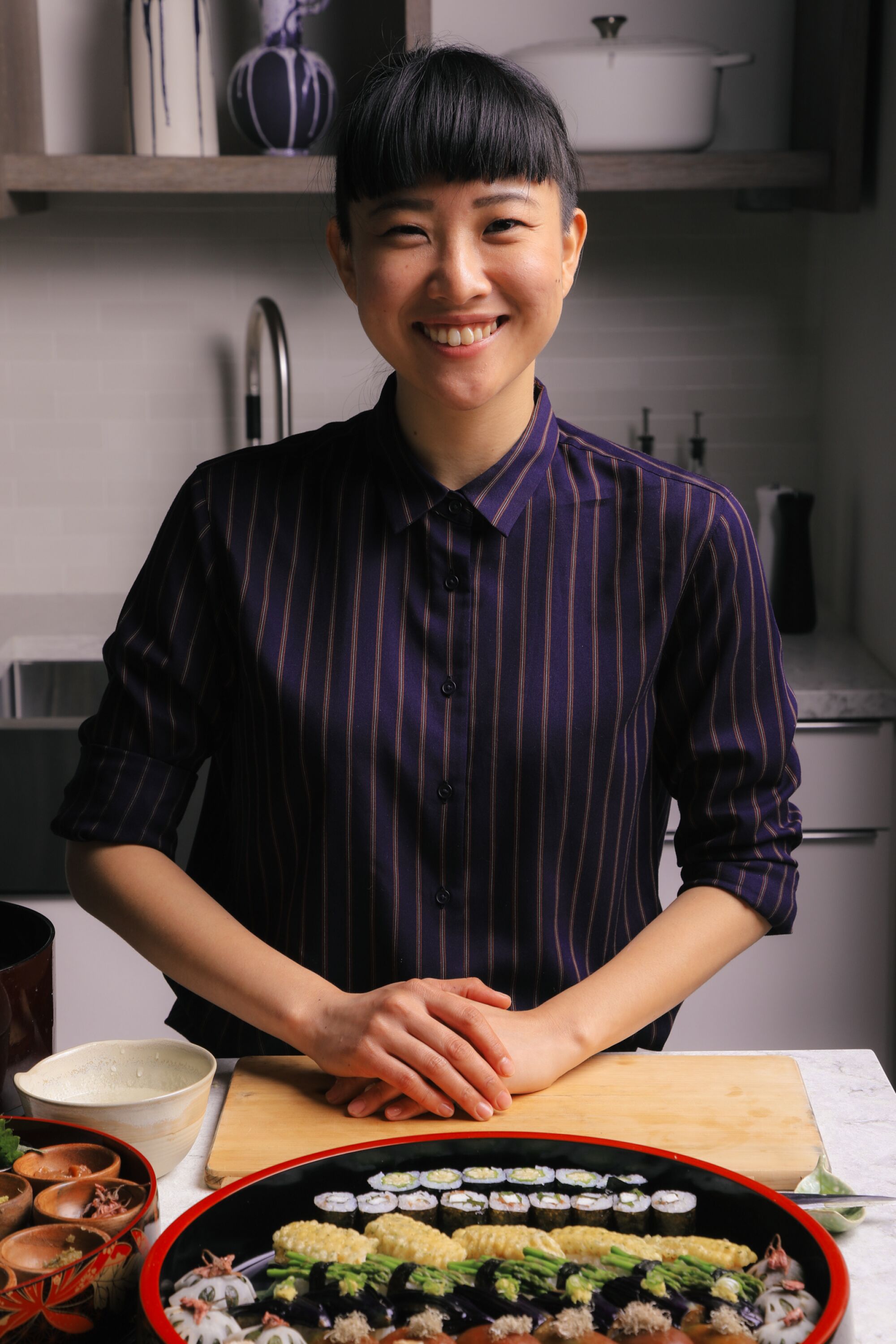A portrait of chef Yoko Hasebe with a platter of her vegan sushi.