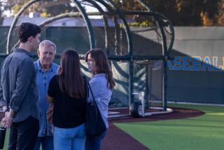 West Los Angeles, CA - August 21: U.S. District Judge David O. Carter, second from left, confers with his law clerks while touring Jackie Robinson Stadium on Wednesday, Aug. 21, 2024 in West Los Angeles, CA. The stadium is on land leased from the VA and a lawsuit alleges that the Department of Veterans Affairs has illegally leased veteran land. (Brian van der Brug / Los Angeles Times)