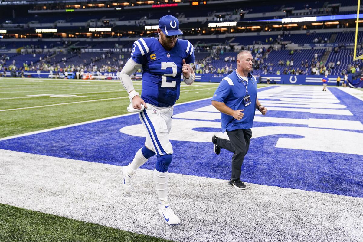 Indianapolis Colts quarterback Carson Wentz (2) runs off the field following a 28-16 loss to the Seattle Seahawks in an NFL football game in Indianapolis, Sunday, Sept. 12, 2021. (AP Photo/Charlie Neibergall)
