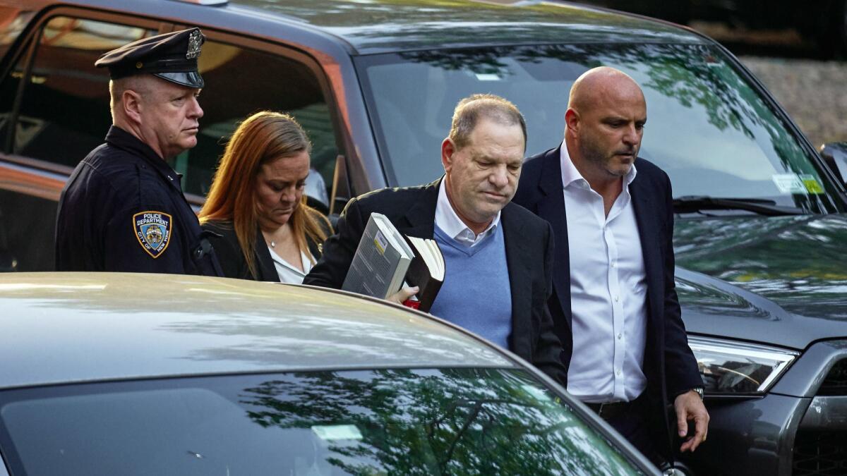 Harvey Weinstein, second from right, surrendered to authorities in New York on Friday.