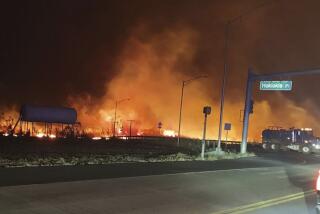 Fire and smoke fill the sky from wildfires on the intersection at Hokiokio Place and Lahaina Bypass in Maui. (Zeke Kalua)