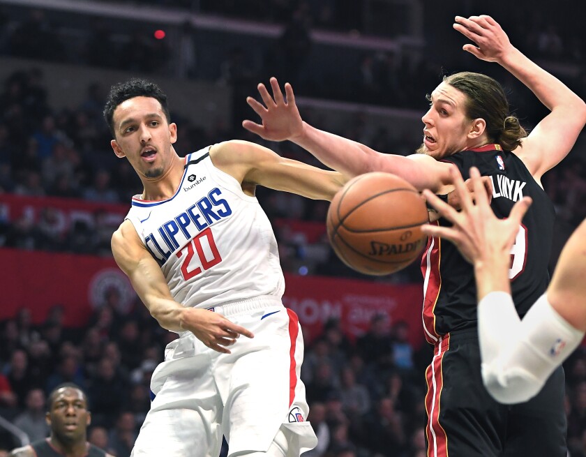 Clippers guard Landry Shamet passes the ball around Heat center Kelly Olynyk during the third quarter Feb. 5, 2020.