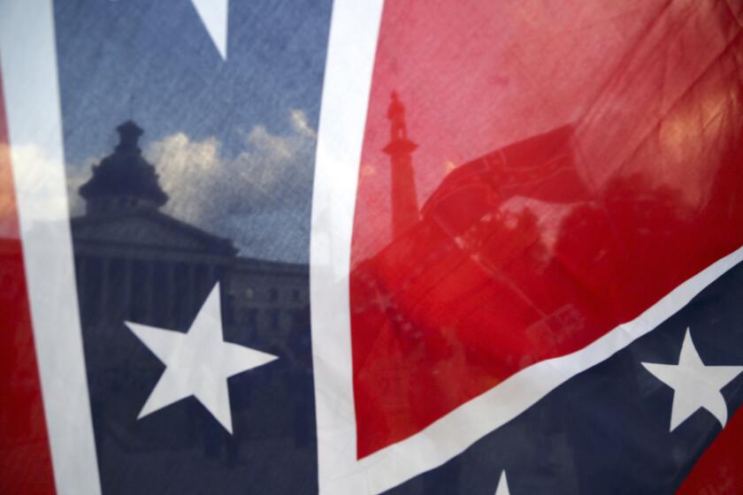 The South Carolina Statehouse is seen through a Confederate flag in Columbia.