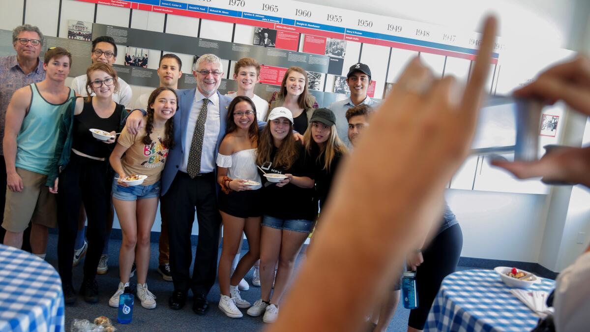 Daniele Struppa, center, the new president of Chapman University, poses for a photo with Chapman students during an ice cream social.