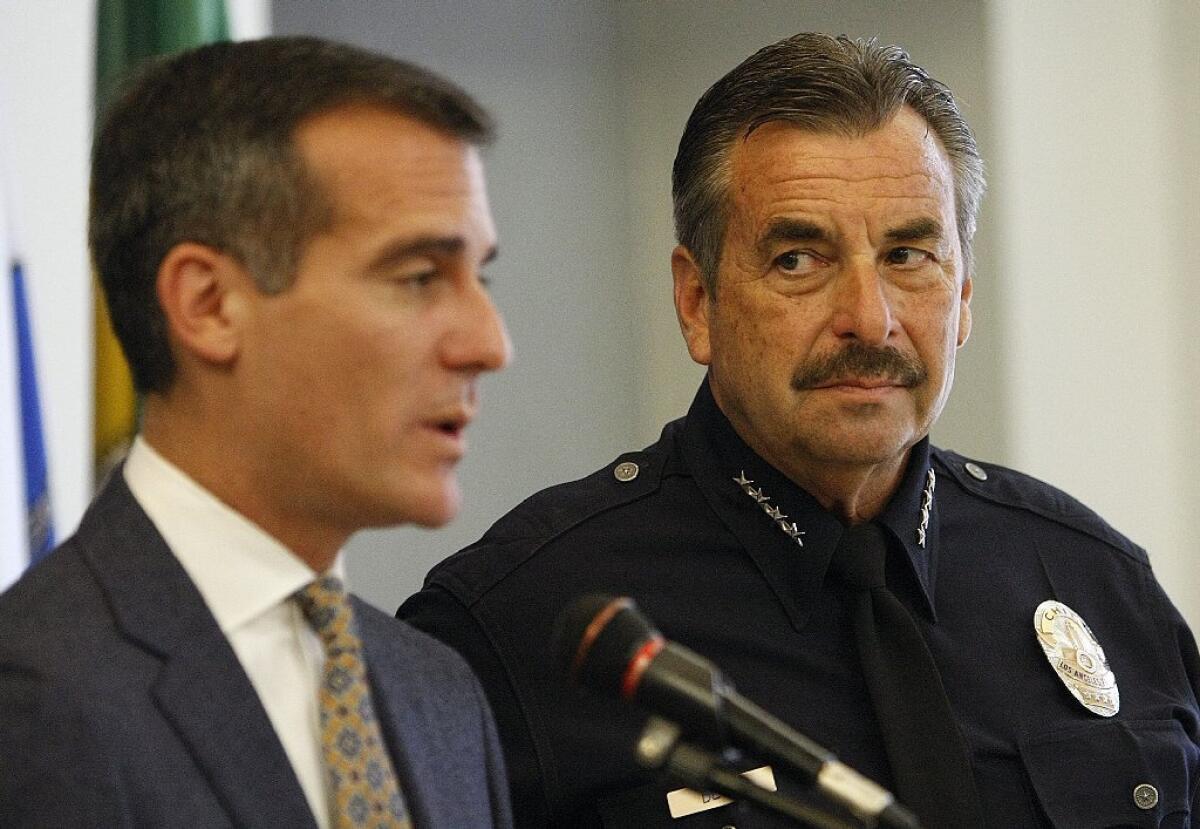 The Los Angeles police officers union has rejected a proposed one-year contract extension agreement reached with city negotiators and Mayor Eric Garcetti, left, with LAPD Chief Charlie Beck.