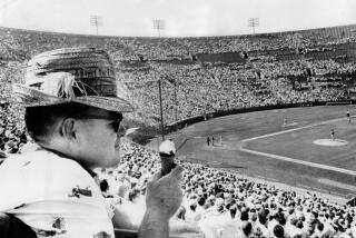 April 17, 1961: Los Angeles Dodger fan eats ice cream cone during game at the Los Angeles Memorial Coliseum.