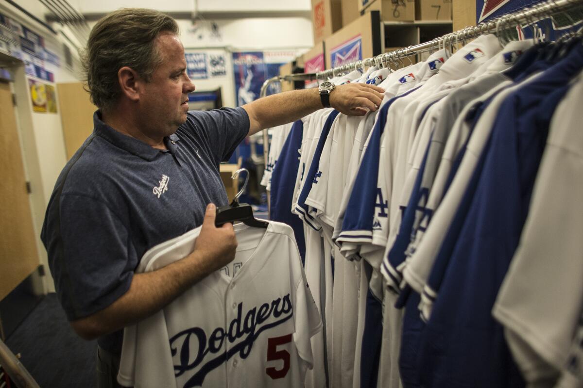 A fan holds up a jersey for Los Angeles Dodgers' Manny Ramirez