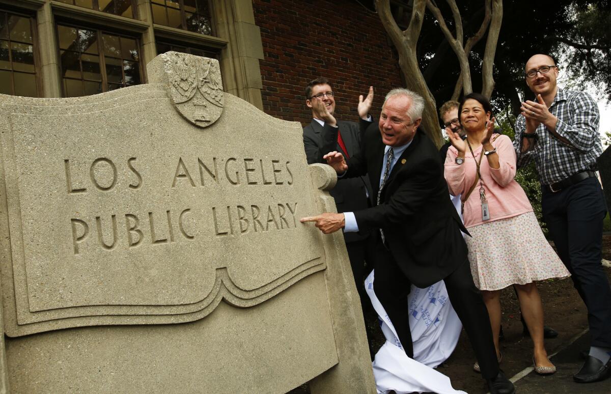 Los Angeles City Councilman Tom LaBonge unveils a historic monument at the Memorial Branch Library on June 24, 2013.