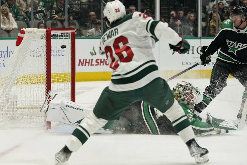 Minnesota Wild center Connor Dewar (26) scores a goal against Dallas Stars goaltender Jake Oettinger (29) and defenseman Ryan Suter (20) during the second period of an NHL hockey game in Dallas, Sunday, Dec. 4, 2022. (AP Photo/LM Otero)