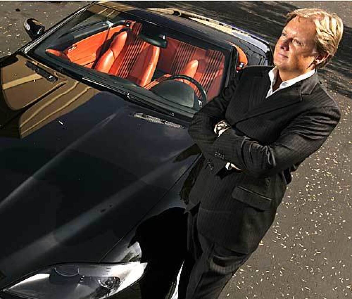 Henrik Fisker, chief executive of Fisker Automotive, poses with one of his most recent creations, the Tramonto.