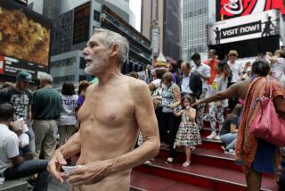 George Davis, a candidate for the San Francisco Board of Supervisors, makes a speech in the nude on Times Square, Wednesday, Aug. 6, 2014, in New York. Davis spoke out against a 2013 San Francisco public nudity ban that was introduced by his opponent, Scott Wiener, saying nudity is a freedom of expression. (AP Photo/Julie Jacobson)
