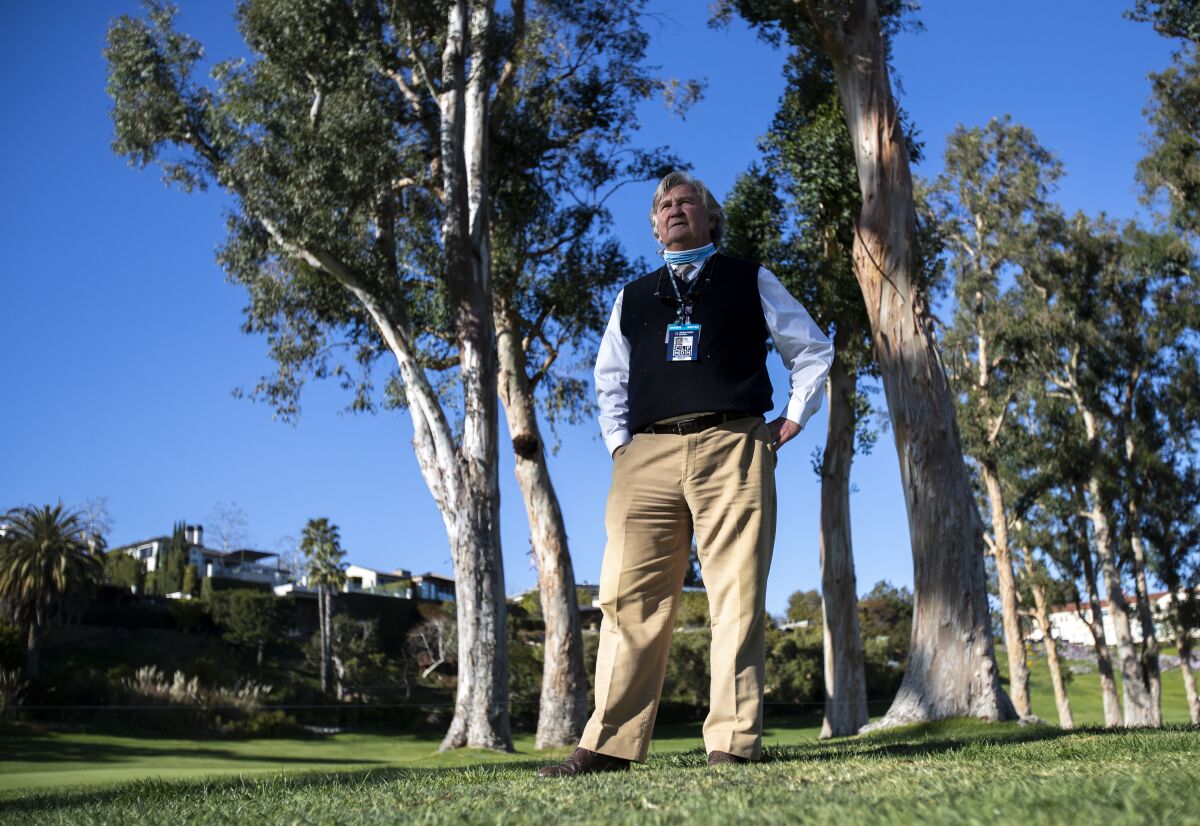 PGA Tour rules consultant Mark Russell stands among the signature eucalyptus trees along the 18th fairway at Riviera.