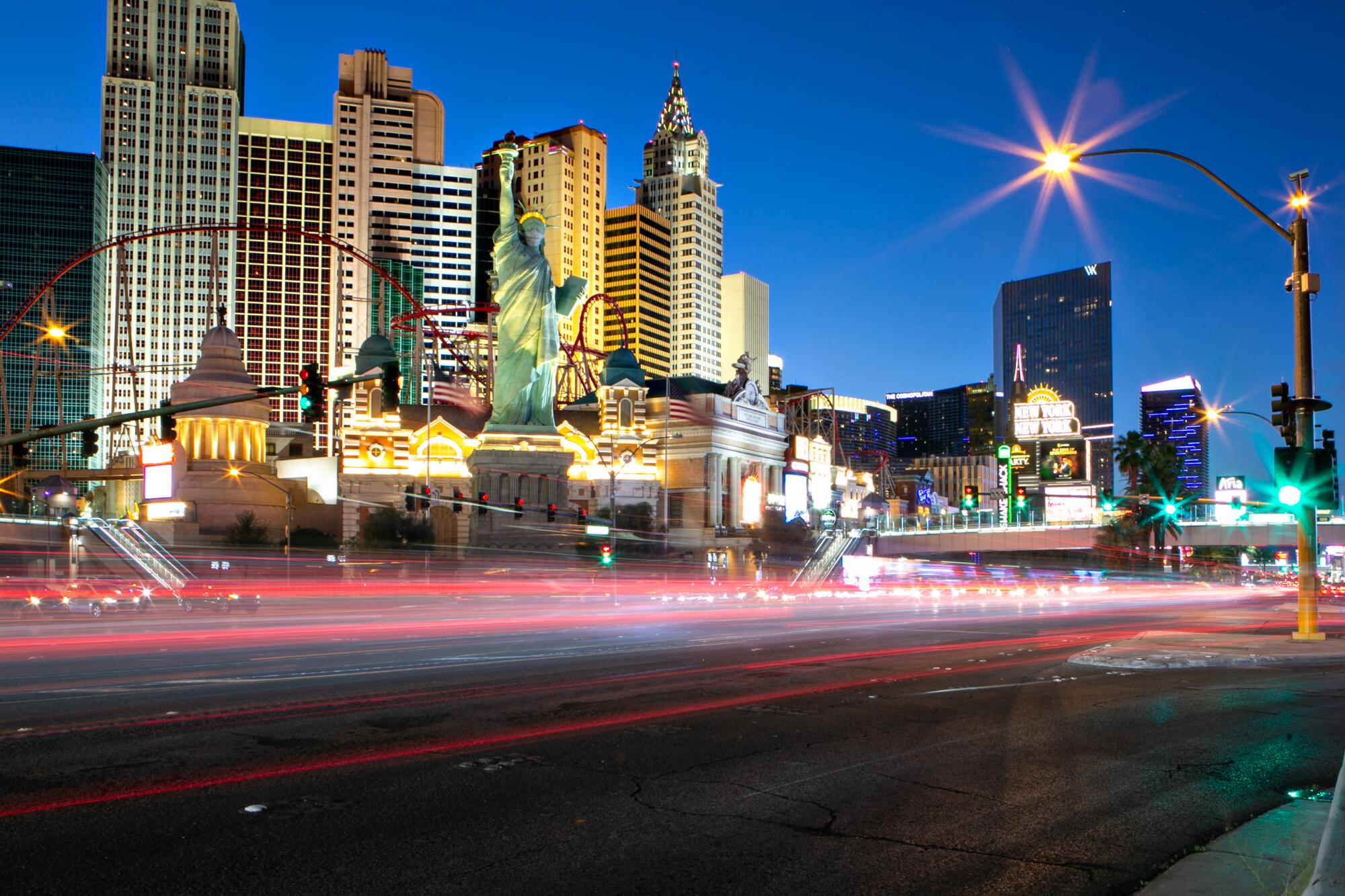 A view of the Las Vegas Strip with blurred headlights from passing cars.