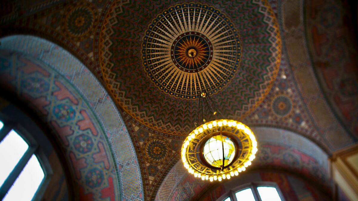 Mosaic–like dome decorations by Julian E. Garnsey and the globe chandelier, which is part of a model of the solar system, are part of the Lodwrick M. Cook Rotunda at the downtown's Central Library.