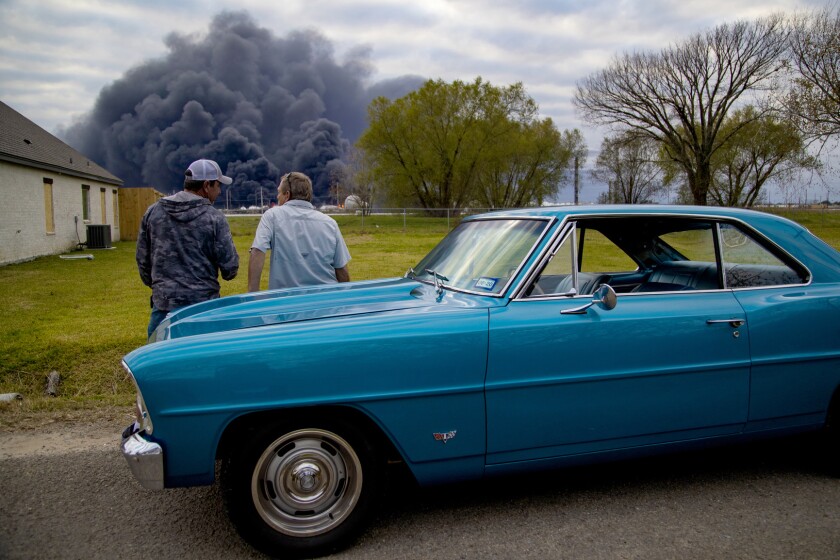 Ray Moore and Milton Perio observe the fire consuming TPC Group plant on Wednesday in Port Neches, Texas.