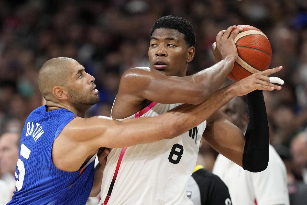 France's Nicolas Batum, left, guards Japan's Rui Hachimura during a group play game.