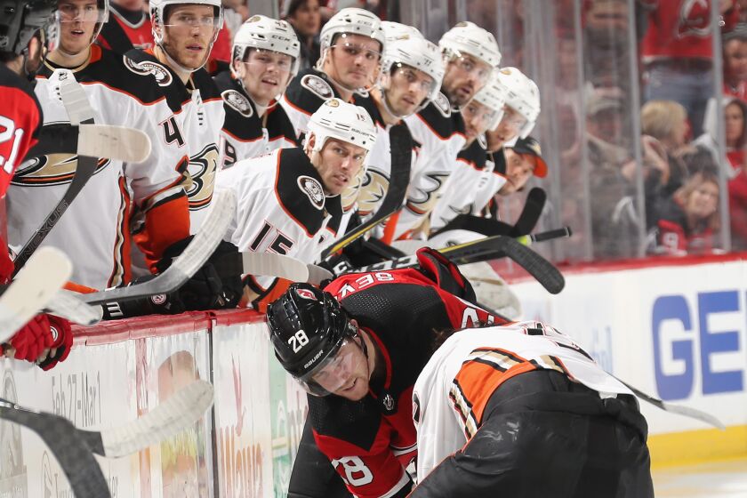 The Ducks' bench watches a fight between left wing Max Comtois and Devils defenseman Damon Severson during a game Dec. 18.