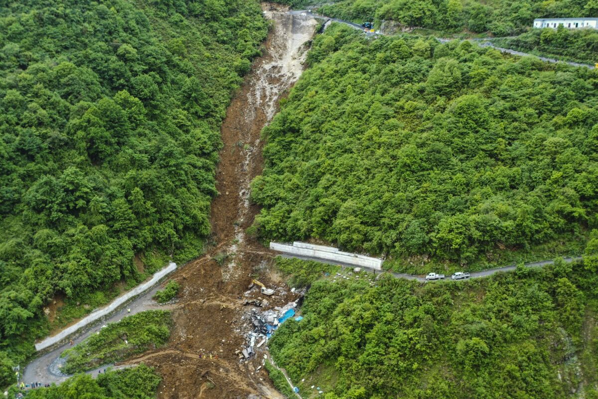 This aerial photo released by the Xinhua News Agency shows the site of a mountain collapse in Leshan in southwestern China's Sichuan Province on Sunday, June 4, 2023. A landslide tore through a mining company's worker dormitory early Sunday morning in southwestern China, killing more than a dozen people, authorities said. (Xinhua via AP)