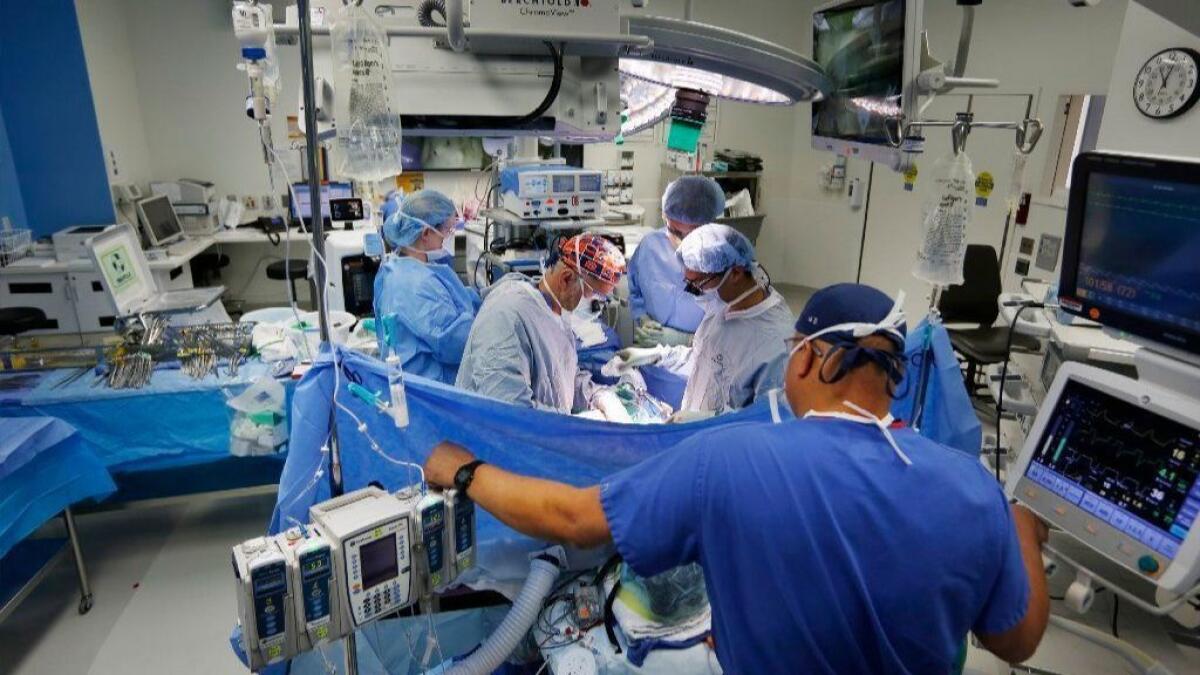 A team of physicians and other medical personnel perform a surgery at the Jacobs Medical Center at UC San Diego Health on Nov. 28.