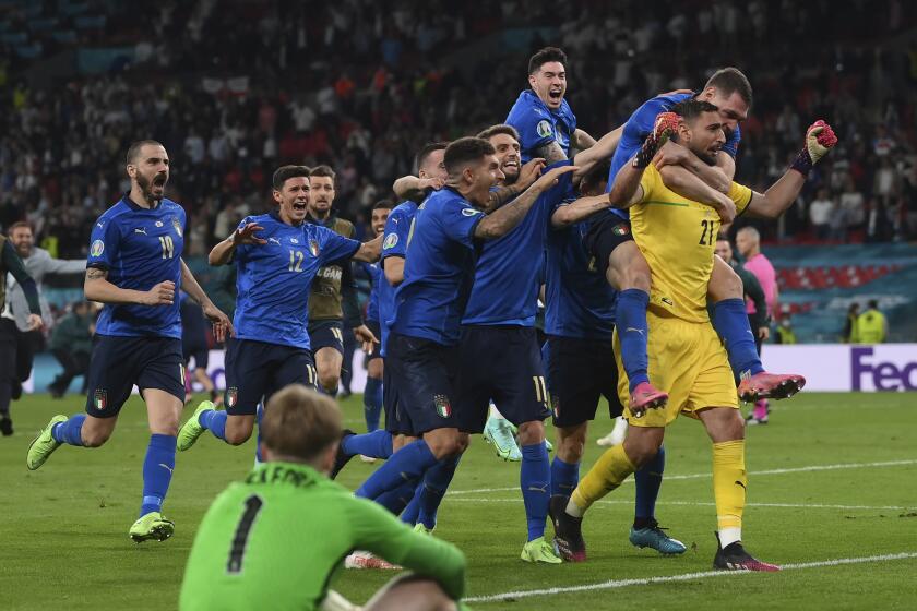 Italian players celebrate after the penalty shootout of the Euro 2020 soccer final match.