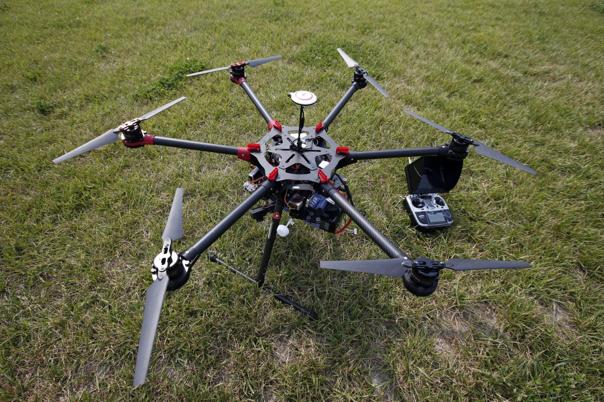 A hexacopter drone and controller at a demonstration at a farm and winery.