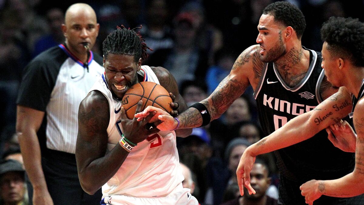 Clippers forward Montrezl Harrell fights for a rebound with Kings center Willie Cauley-Stein (00) and guard Malachi Richardson during the second half Tuesday night.