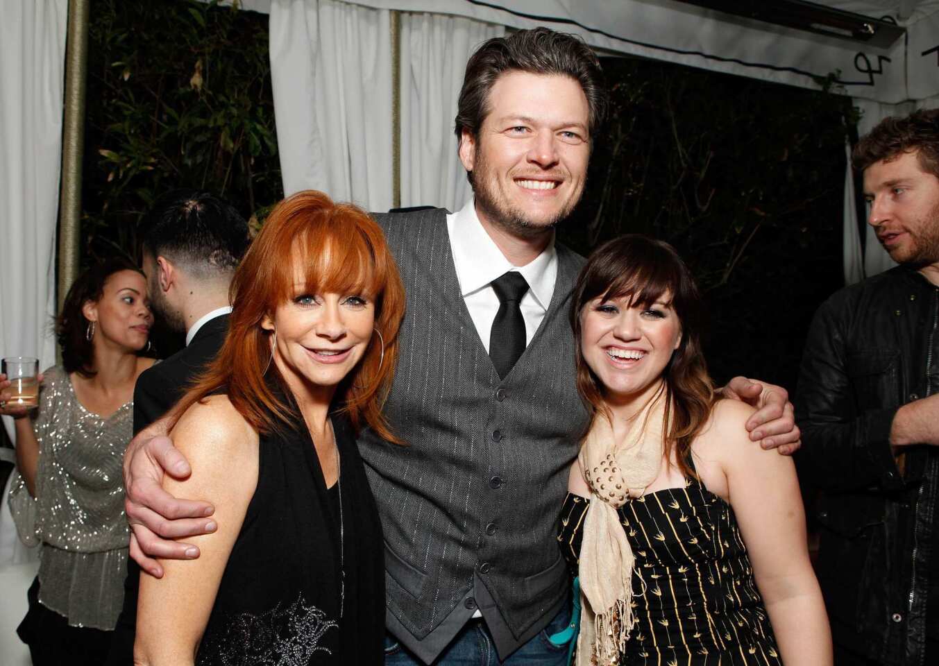 Country music singer Reba McEntire, left, with "The Voice" judge Blake Shelton and "American Idol" alum Kelly Clarkson.