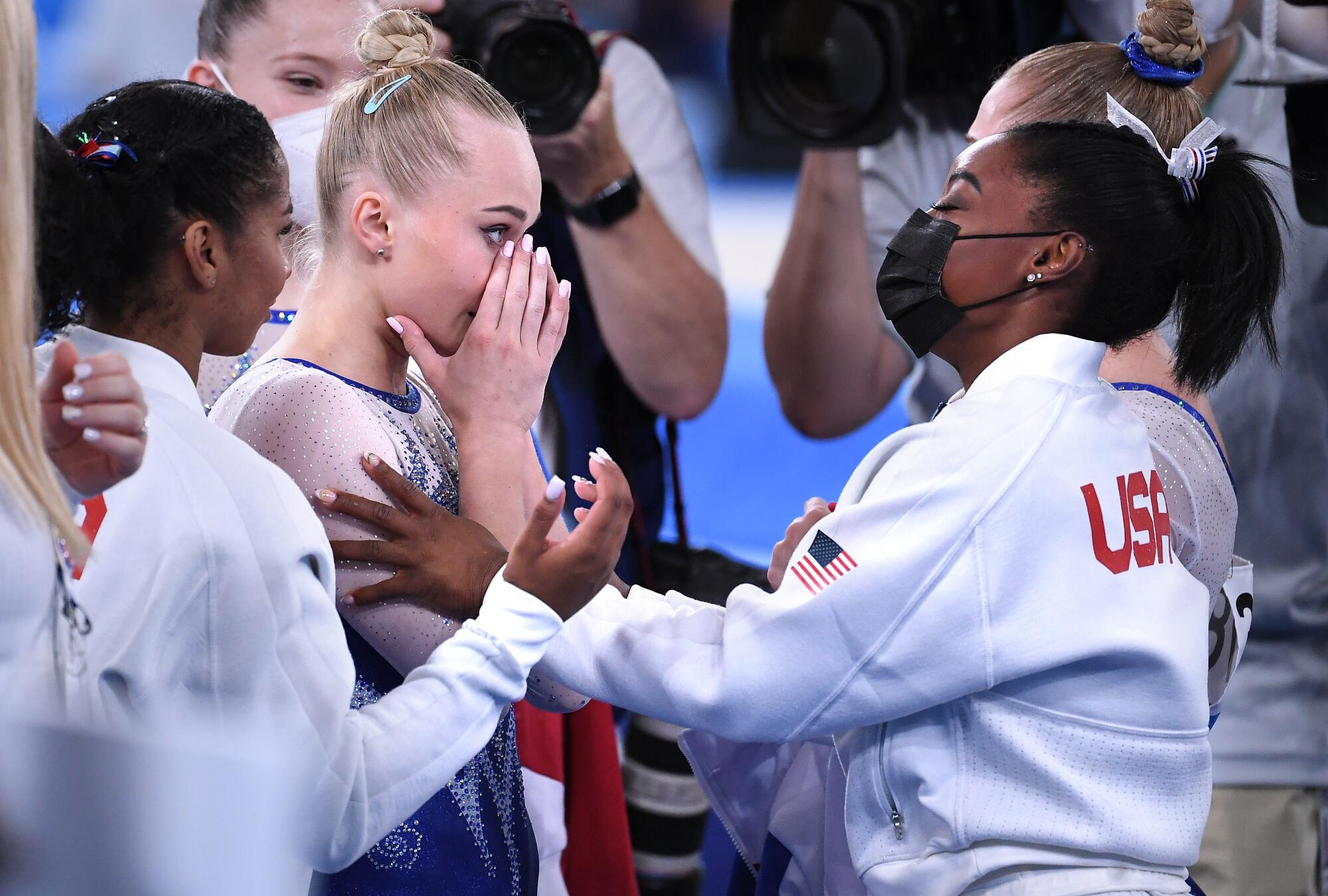 U.S. gymnast Simone Biles, right, and Russia's Angelina Melnikova embrace after the women's team final.