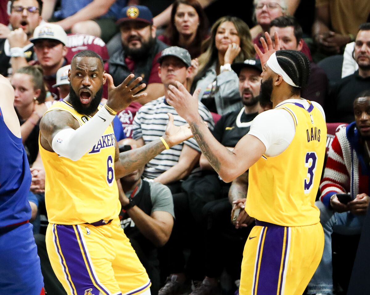 Lakers forwards LeBron James, left, and Anthony Davis throw up their arms in reaction to a foul call during Game 1.