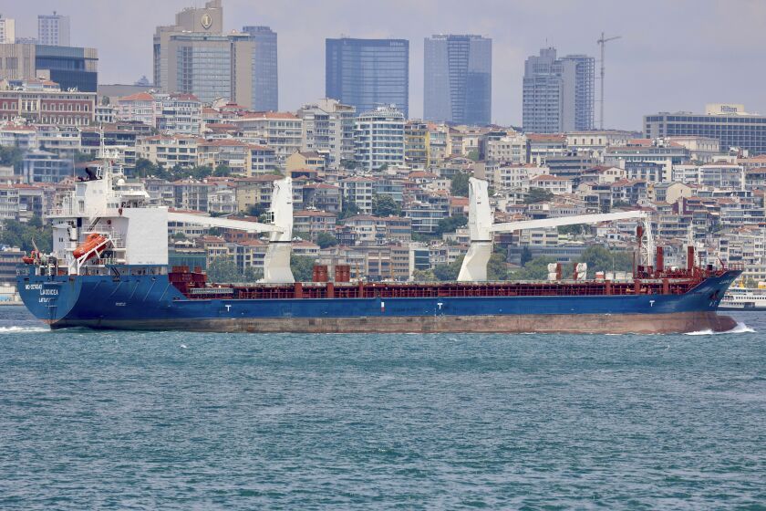The cargo ship Laodicea sails through the Bosphorus Strait in Istanbul, Turkey, on July 7, 2022. An Associated Press investigation shows the ship, owned by the Syrian government, is part of an extensive Russian-run smuggling operation that has been hauling stolen Ukrainian grain from ports in occupied Crimea to customers in the Middle East. (AP Photo/Yoruk Isik)