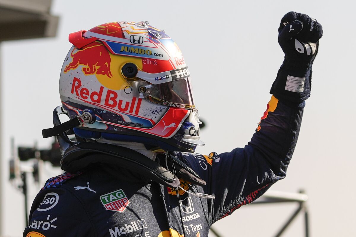 Red Bull driver Max Verstappen of the Netherlands celebrates clinching the pole position after the qualifying session for Sunday's Formula One Dutch Grand Prix at the Zandvoort racetrack, Netherlands, Saturday, Sept. 4, 2021. (AP Photo/Francisco Seco, Pool)