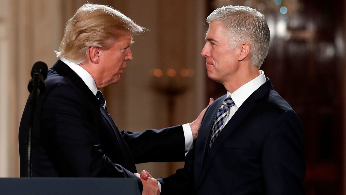 President Trump shakes hands with Neil Gorsuch, his choice for Supreme Court associate justice, in the White House on Jan. 31.