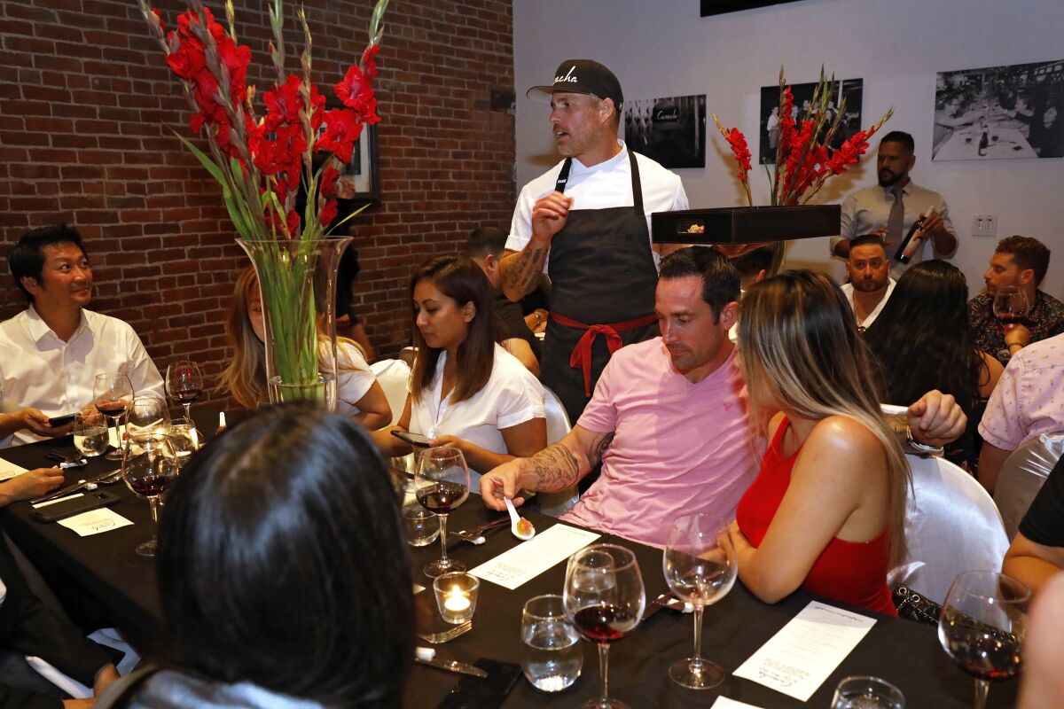 A photo of Steve Brown chatting with diners at Cosecha SD