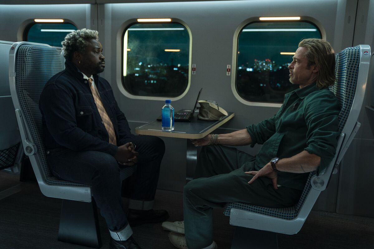 This image released by Sony Pictures shows Bryan Tyree Henry, left, and Brad Pitt in a scene from "Bullet Train." (Scott Garfield/Sony Pictures via AP)