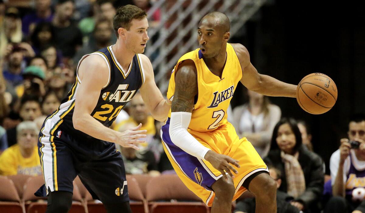 Lakers guard Kobe Bryant works in the post against Jazz forward Gordon Hayward during the first half of a preseason game in Anaheim.