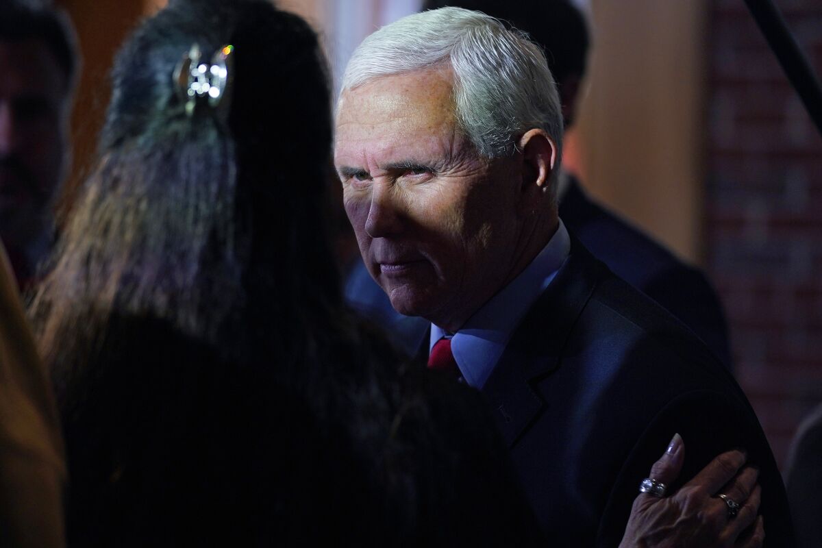 Former Vice President Mike Pence talks with guests during a gathering, Wednesday, Dec. 8, 2021, in Manchester, N.H. (AP Photo/Charles Krupa)