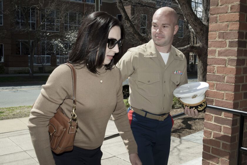 Marine Maj. Joshua Mast and his wife, Stephanie, arrive at Circuit Court, Thursday, March 30, 2023 in Charlottesville, Va. In a highly unusual ruling, a state court judge on Thursday voided a U.S. Marine’s adoption of an Afghan war orphan, more than a year after he took the little girl away from the Afghan couple raising her. But her future remains uncertain. (AP Photo/Cliff Owen)