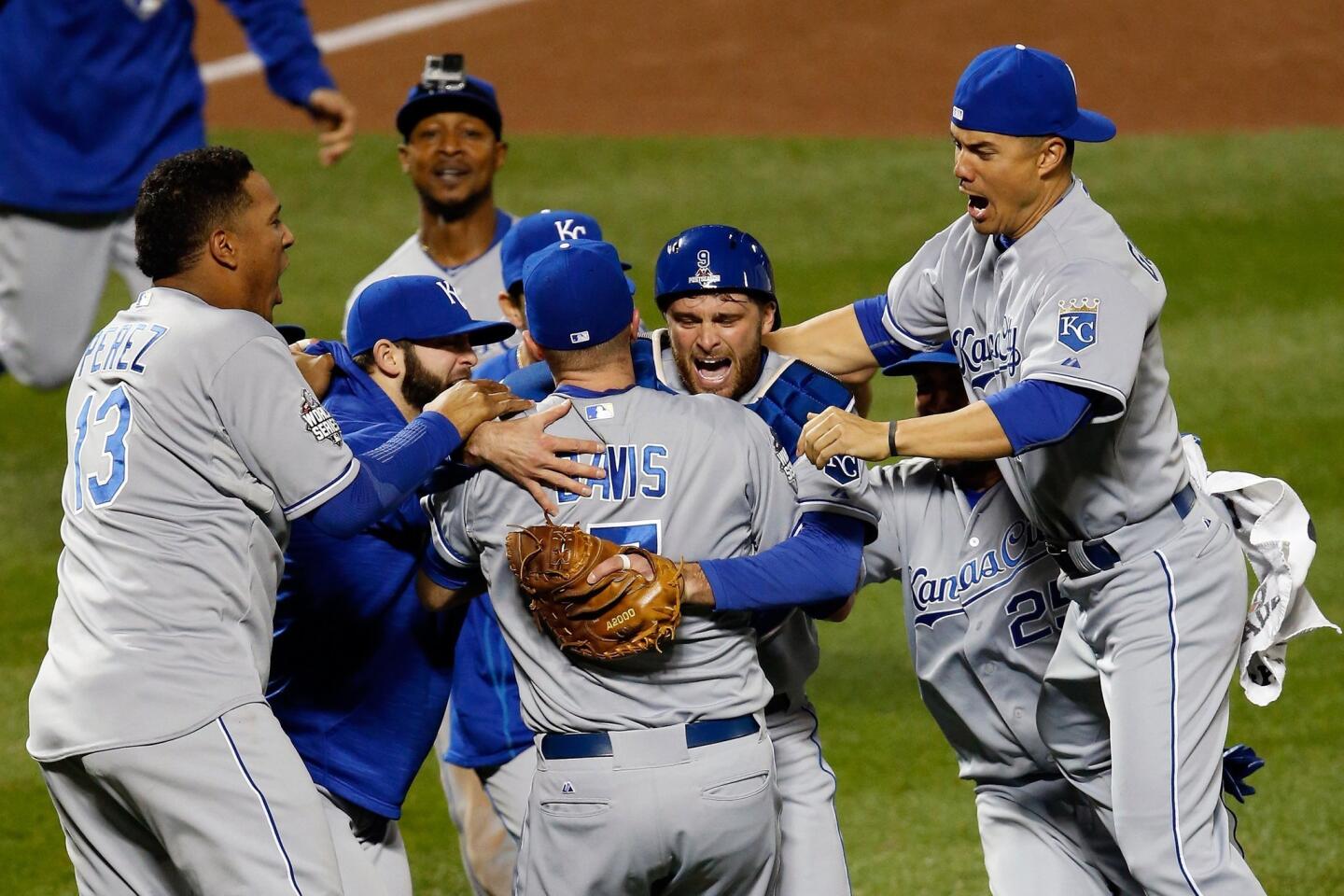 Wade Davis #17 of the Kansas City Royals and Drew Butera #9 of the Kansas City Royals celebrate with teammates after defeating the New York Mets to win Game Five of the 2015 World Series at Citi Field.