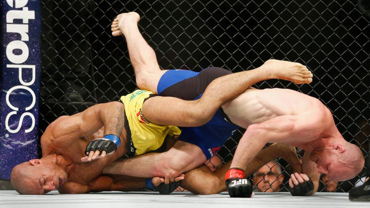 Roan Carneiro, left, goes for a leg lock against Ryan LaFlare during their welterweight fight at UFC 208. To see more images, click on the photo above.