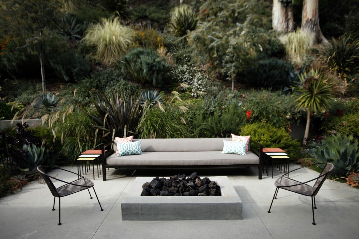 Landscape designer Judy Kameon designed an extra-long sofa and fire pit for an outdoor seating area in this 1953 Brentwood ranch house.