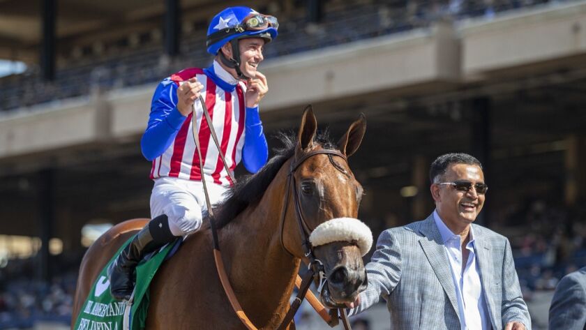 Owner Kaleem Shah guides Bellafina and jockey Flavien Prat to the winner's circle after their victory in the Grade I $300,000 Del Mar Debutante in September.